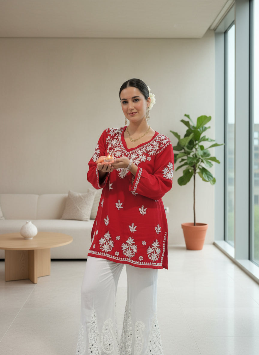 model wearing Chikankari short kurti with V neck in red with white embroidery and white pants