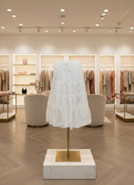 White lace skirt with embroidery on a rack