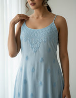close up of this sky blue Chikankari muslin fabric noodle dress with hand embroidery by famaza couture 