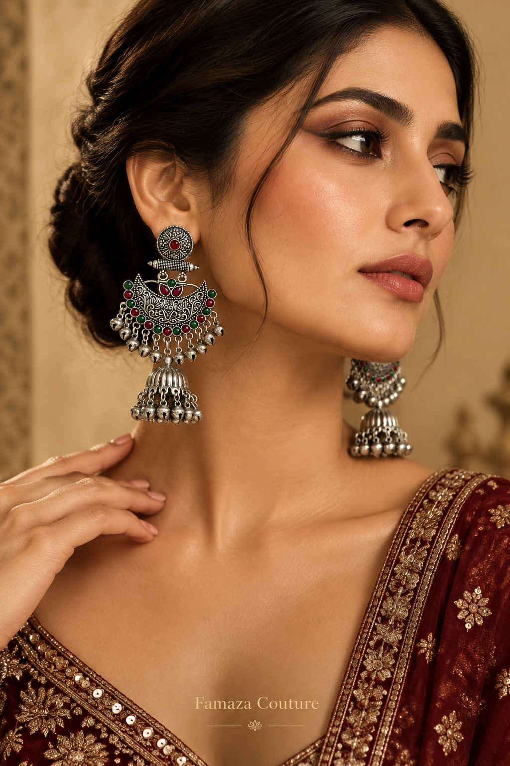 Model wearing Deepika silver-tone Chandbali jhumka earrings with red and green accents and a maroon embroidered outfit.