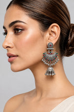 Model wearing Deepika oxidised silver-tone Chandbali jhumka earrings with red and green accents.