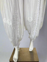 White Chikankari embroidery Dhoti Pants Tulip Trousers on mannequin