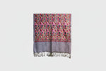 The beige base colour a Kashmiri embroidered pashmina scarf with floral and geometric patterns primarily in pink, gray, and multicolor tones, featuring tassels on the ends.