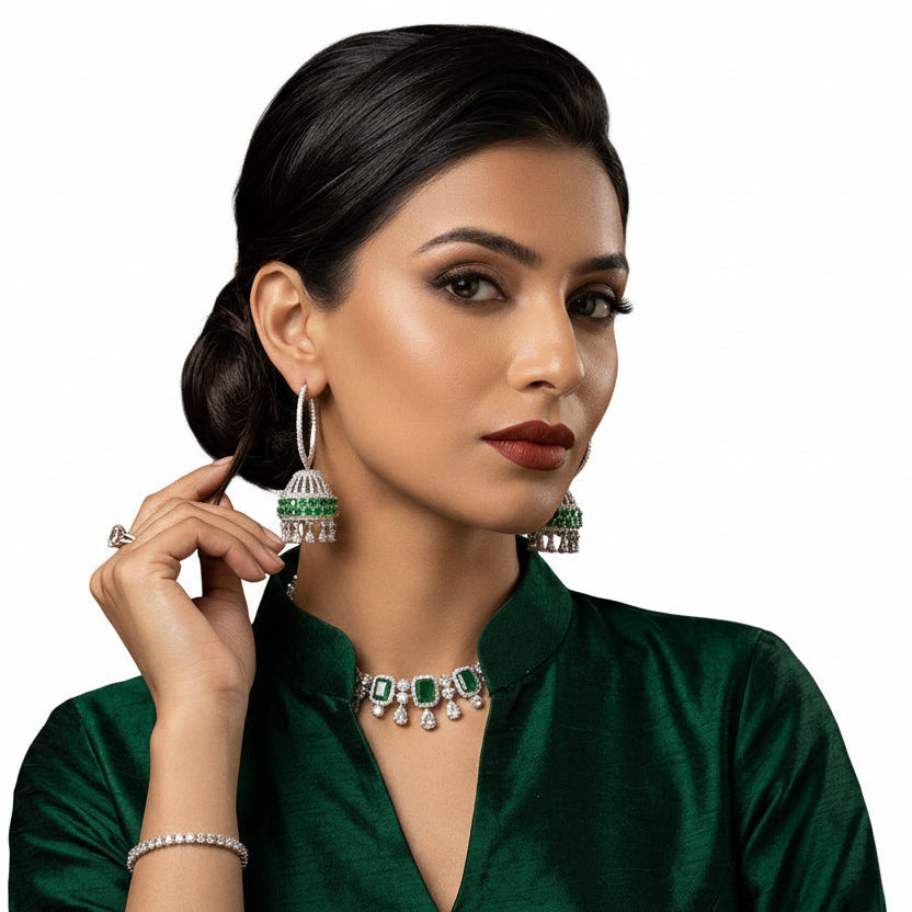 Model wearing Emerald Green and American Diamond Hoop Jhumka Earrings with silver-tone finish for wedding guest look.