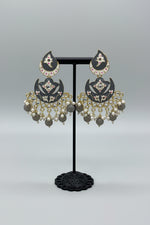 enamel painted grey colour Pair of earrings displayed on a stand. 