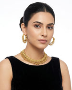 Model in a black outfit wearing the Gilded Grace gold-toned choker and matching hoop earrings.
