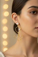 Elegant handcrafted gold plated brass dangling earrings featuring high-lustre pearl drops, ideal for bridal jewellery, posh evening wear, and English party style.