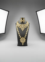  gold-toned Kundan oval choker necklace and mala necklace with polki kundan embellishments and matching earrings by famaza couture 