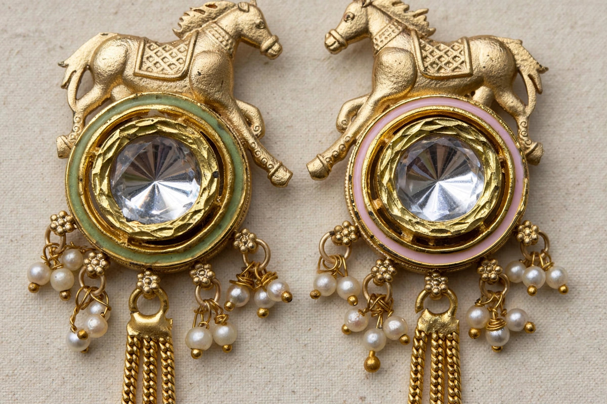 Close-up of Golden Gallop horse motifs, reflective kundan centres, green and pink enamel borders and clustered pearl-style beads.