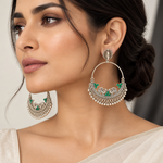 Green worn on model: Model wearing silver-tone peacock chandbali earrings with green accents and ghungroo fringe, paired with a cream outfit.