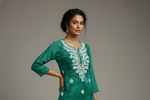 model is wearing this short length bottle green colour kurti in tie & dye colour with white machine embroidery by famaza couture 