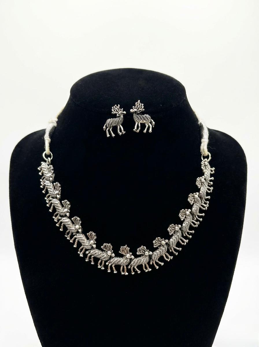 jewellery set featuring the deer trail necklace and matching deer stud earrings in a luxury boutique display.