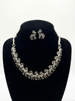 jewellery set featuring the deer trail necklace and matching deer stud earrings in a luxury boutique display.