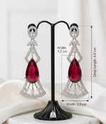 Aurora Jem crimson ruby statement drop earrings with clear cubic zirconia crystal accents in an Art Deco geometric silver-plated design, shown on a model