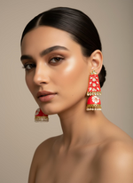 watermelon pink with gold accents on a card held by a hand against a white background
