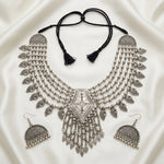 Midnight Heirloom necklace and earrings laid flat, showing paisley charms, pendant fringe and adjustable black cord.