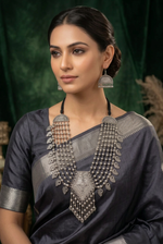 Model wearing Midnight Heirloom layered oxidised necklace and fan-shaped earrings with a grey saree.