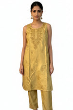 model is wearing gold chanderi silk 2pc dress with matching straight trousers 