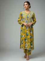 model is wearing this 2PC dress of Mustard colour all over print Mulmul fabricwith white thread chikankari embroidery long kurti and trousers. Please keep the dress same as original don't make any changes in the design.