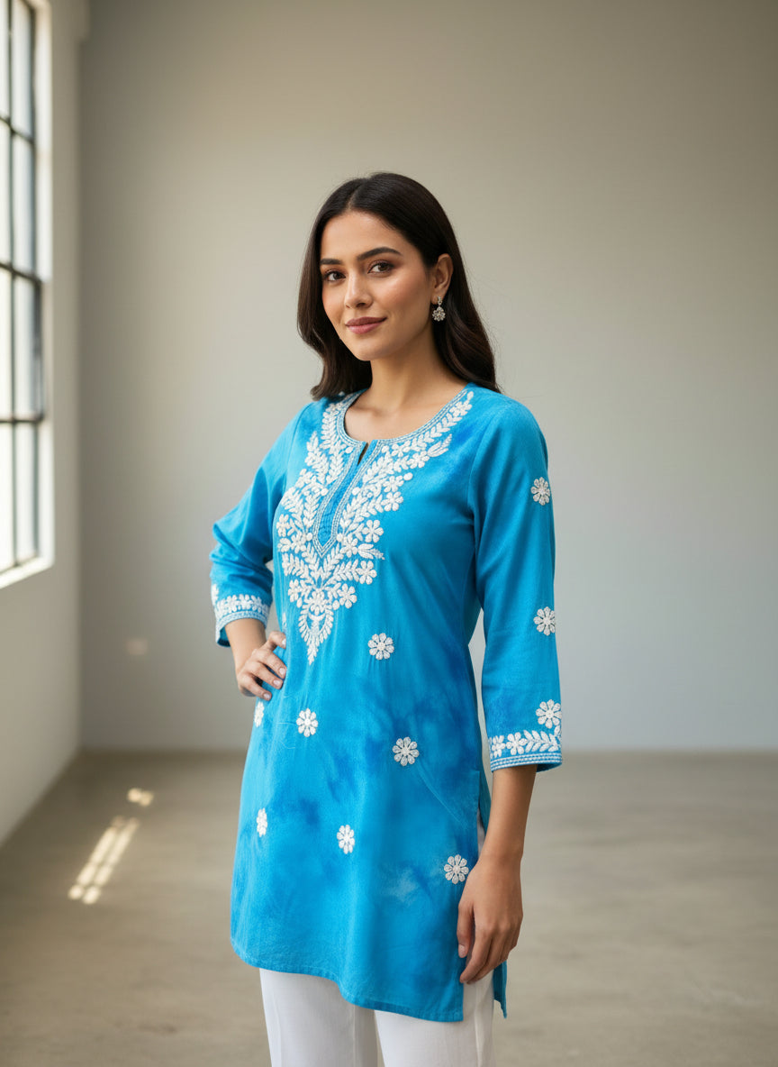 model is wearing this short length blue colour kurti in tie & dye colour with white machine embroidery by famaza couture 