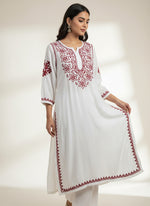 model is wearing white kurti with maroon embroidery 