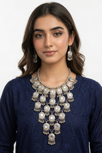 Model wearing the Moonlit Embrace silver-tone necklace and matching drop earrings with a navy blue kurta