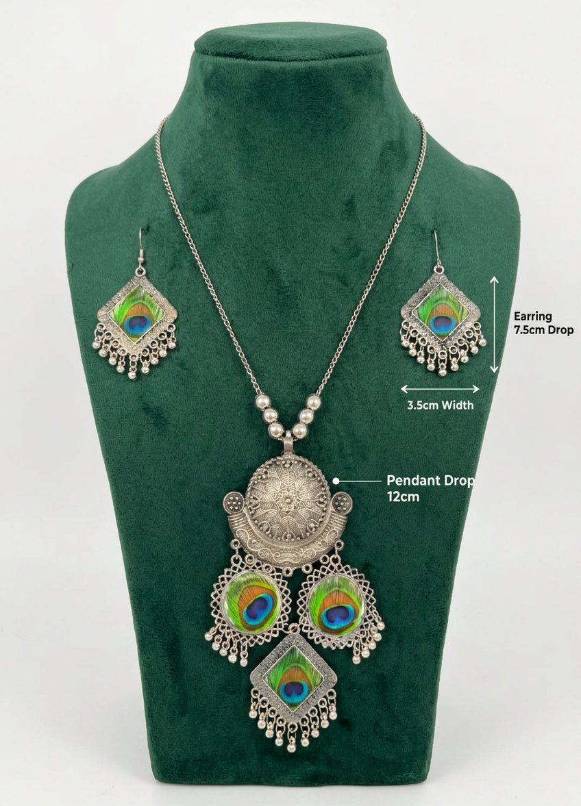 Mor-Mahal oxidised peacock set on a green bust, with labels showing a 12 cm pendant drop and earrings 7.5 cm long by 3.5 cm wide