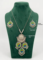 Mor-Mahal oxidised peacock set on a green bust, with labels showing a 12 cm pendant drop and earrings 7.5 cm long by 3.5 cm wide