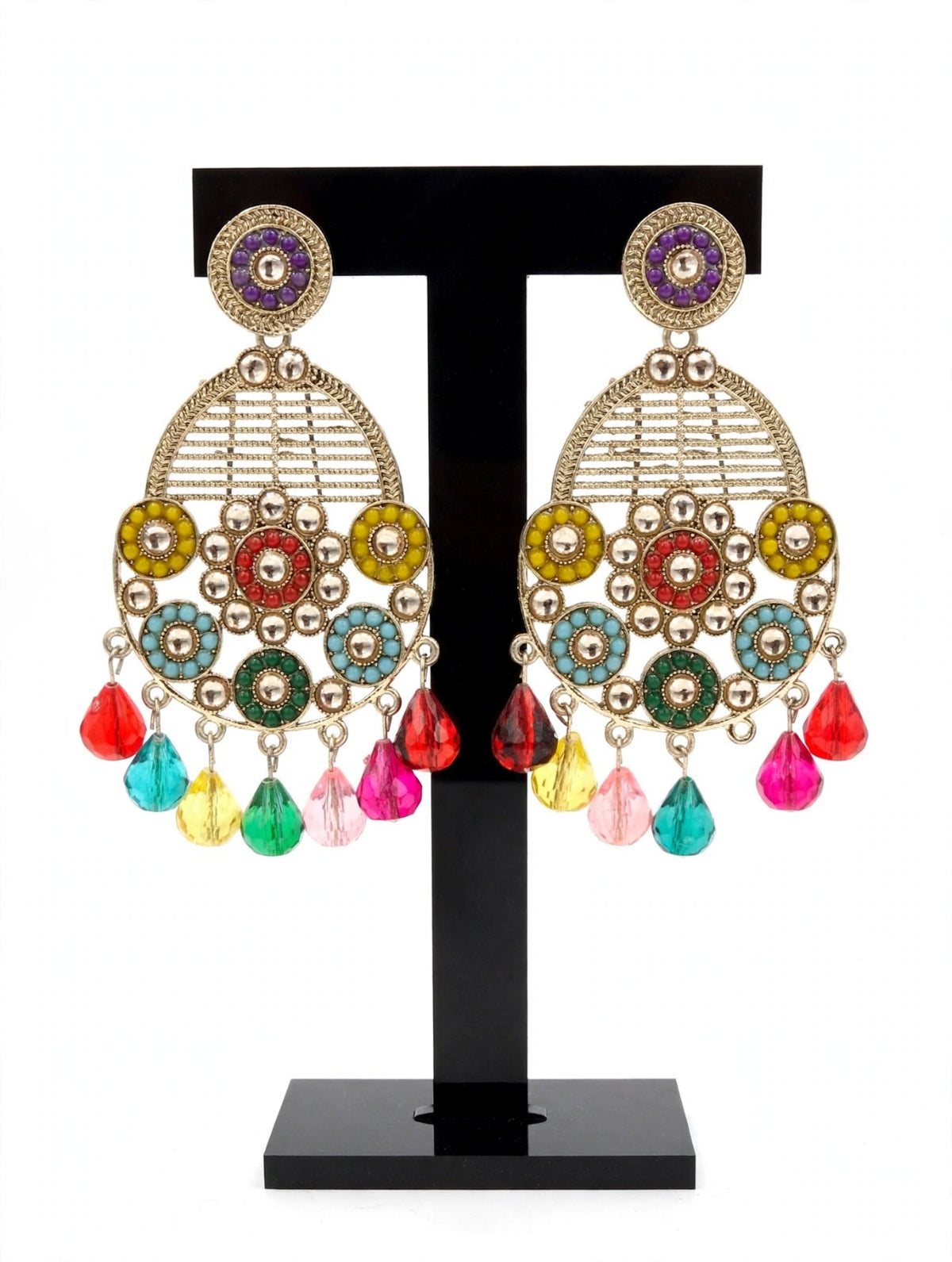 Multicolour floral teardrop earrings in antique gold tone displayed on a black stand.