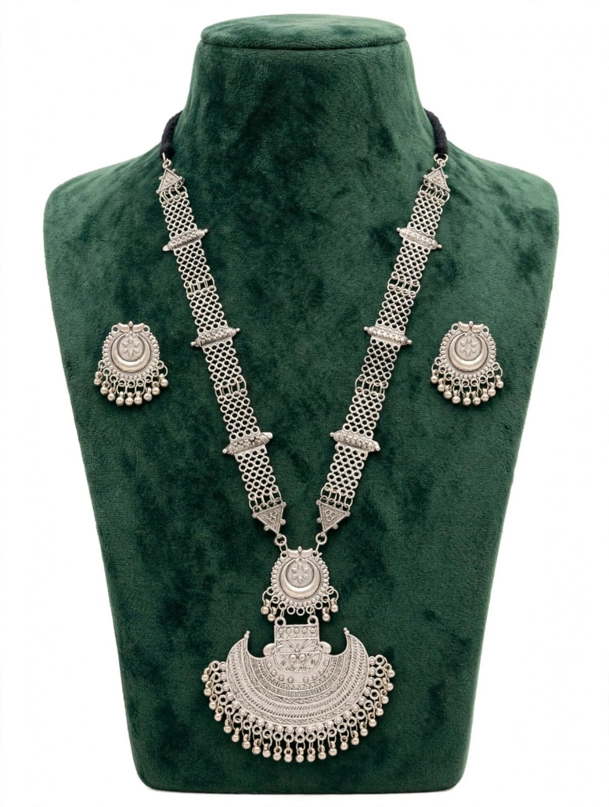 Oxidised silver Afghan Rani Haar Y-shaped necklace set — statement crescent pendant 8.5cm drop × 8cm wide, chain drop 13cm, total weight 25g — mini jhumka stud earrings, black dori cord — displayed on deep green velvet bust stand.