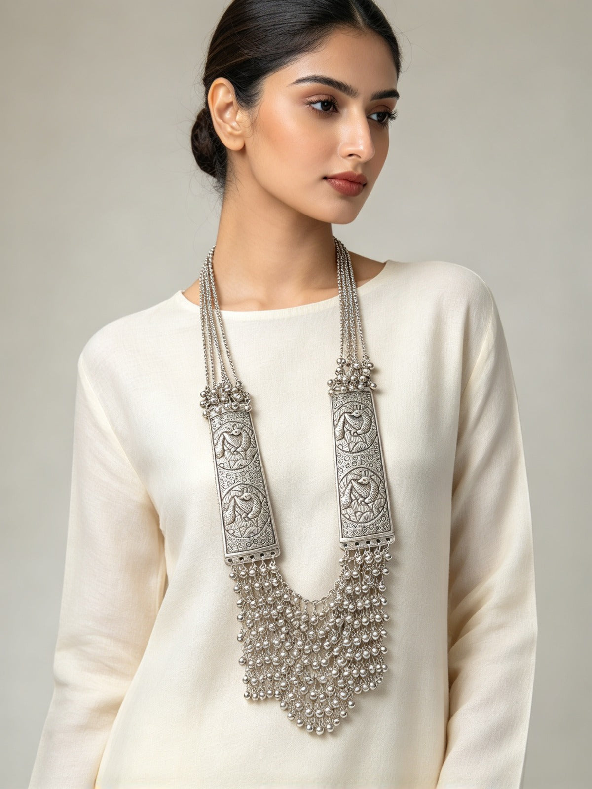 Model wearing the Silver Sonata oxidised long mala necklace with a cream outfit