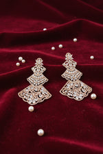 pair of Rose gold-tone three-tiered chandelier earrings with intricate filigree lattice metalwork and sparkling cubic zirconia crystals, displayed on a red velvet jewellery bust.