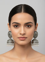 Model wearing silver oxidised filigree drop earrings