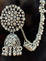 Close-up of a Pakeezah Moonlight jhumka earring showing clear stones, an openwork dome and a beaded Sahara chain.