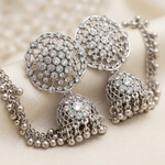 Close-up of Pakeezah Moonlight jhumkas showing clear stones, openwork domes and dangling silver-tone beads.