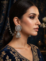 Model in navy and gold wearing Pakeezah Moonlight silver-tone jhumka earrings with Sahara chains.