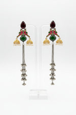 parrot figures golden and black long Kashmiri earrings with mini jhumkas on both sides and green stone in the centre. 