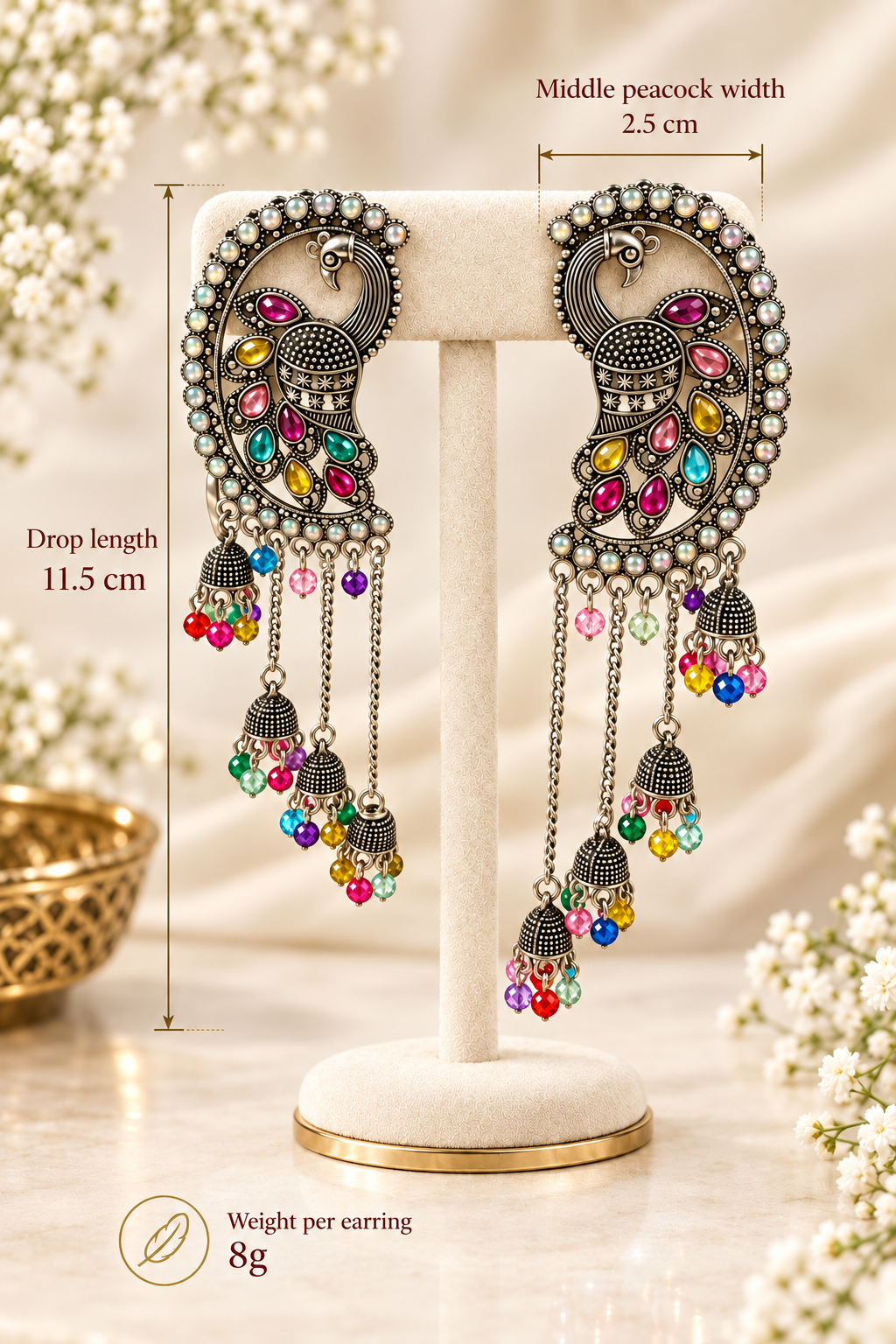 Antique silver peacock meenakari chandbali jhumka earrings — drop length 11.5 cm, peacock width 2.5 cm, weight 8 gm each — displayed on premium gold-tone stand, multicolor stone detailing, Indian Pakistani bridal jewelry.