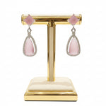  pink stone earrings are displayed on a stand. 