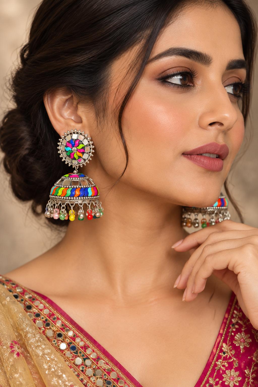 Close-up portrait of a model wearing Famaza Couture multi-coloured plastic and mirror work oxidised jhumka earrings.