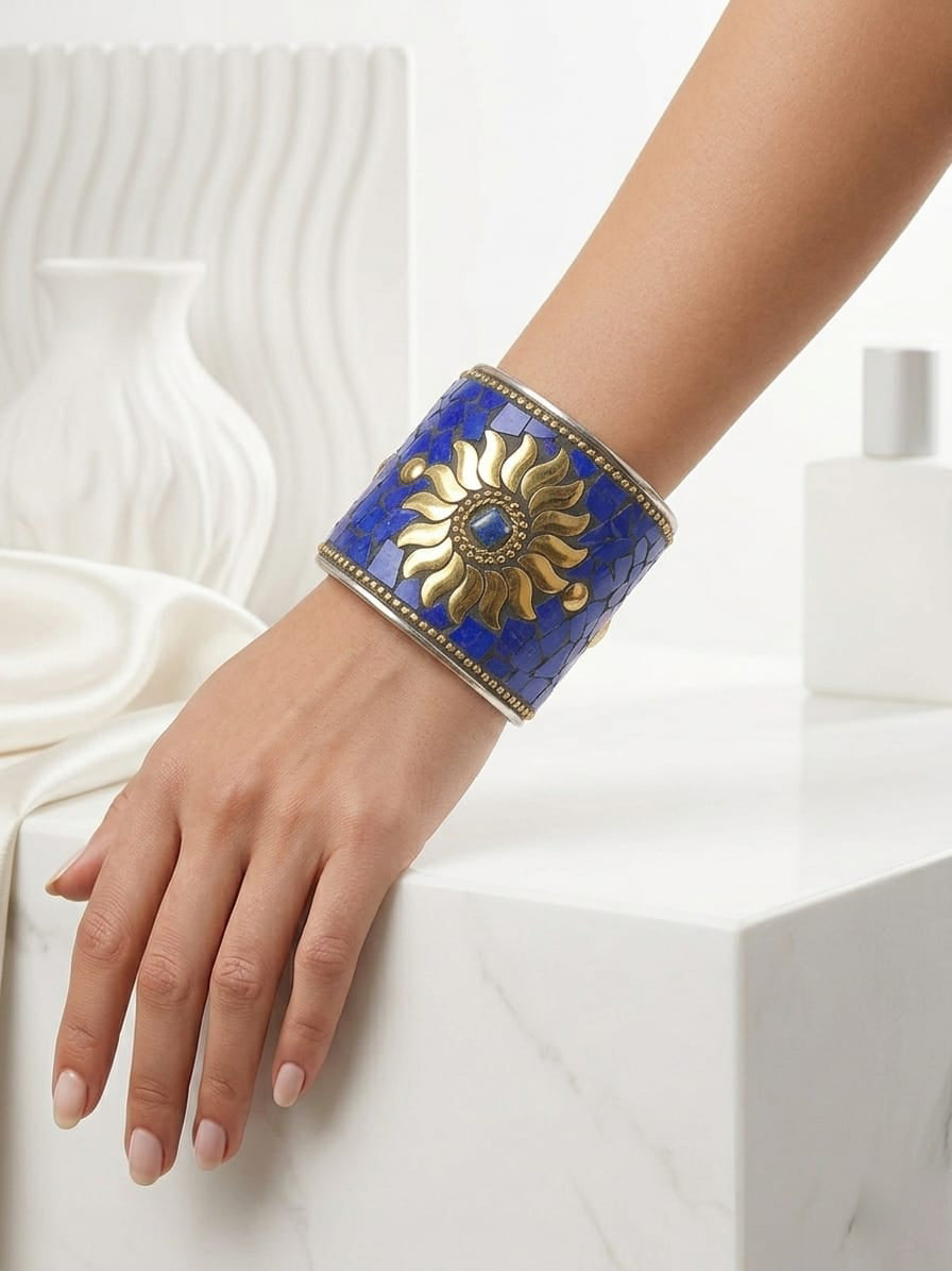 Close-up view of the intricate hand-set royal blue sunburst mosaic stone centerpiece on the artisan heritage cuff