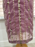 Close-up of the Shan-e-Sheeba lavender shirt hem showing vertical sequin rows, floral embellishments and a sheer chiffon border.