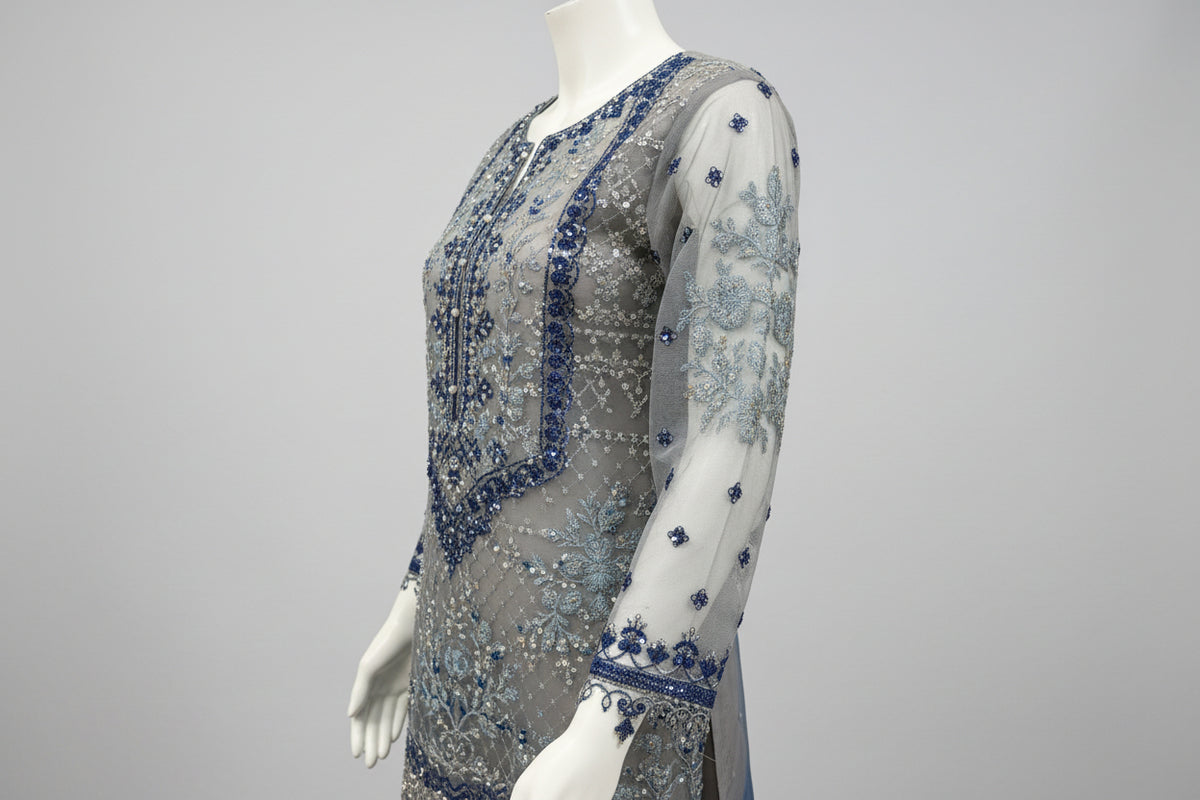 side view and showing sleeves work of Net fabric in grey and navy blue two tone 3pcs Pakistani dress with hand embellishments on all over kurti and dupatta with plain grey silk straight trousers 
