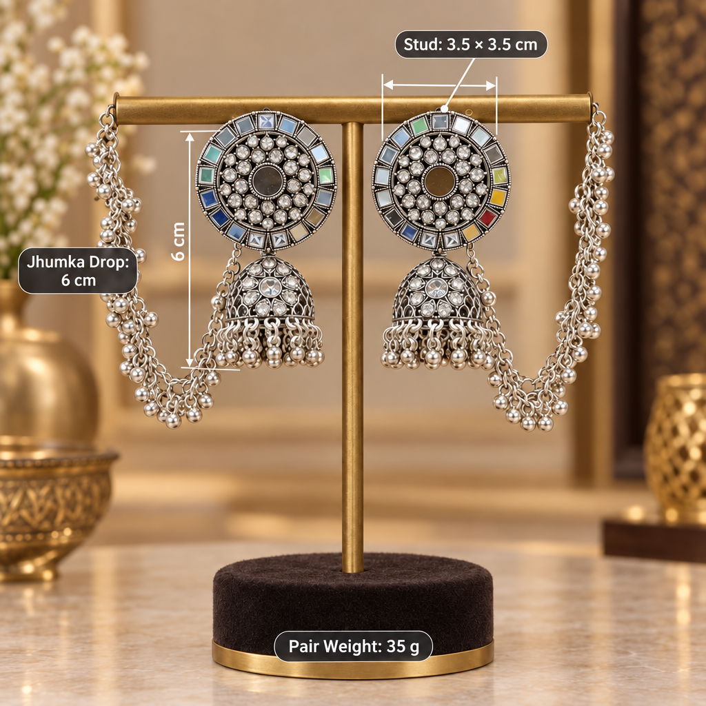 Silver jhumka earrings on an elegant jewellery stand