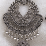 Close-up of paired elephant motifs, ornate openwork and dangling beads on a Silver Serenade chandbali earring.