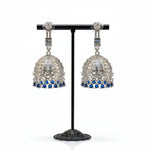 the rear view of the Pair of silver and blue beaded earrings on a stand with a blurred jewellery store background.