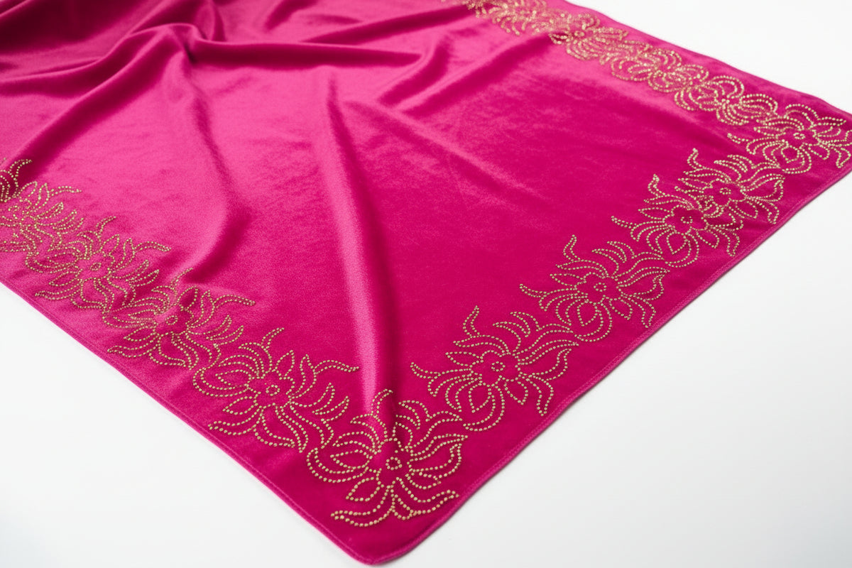 Pink fabric with gold embroidery on a white background