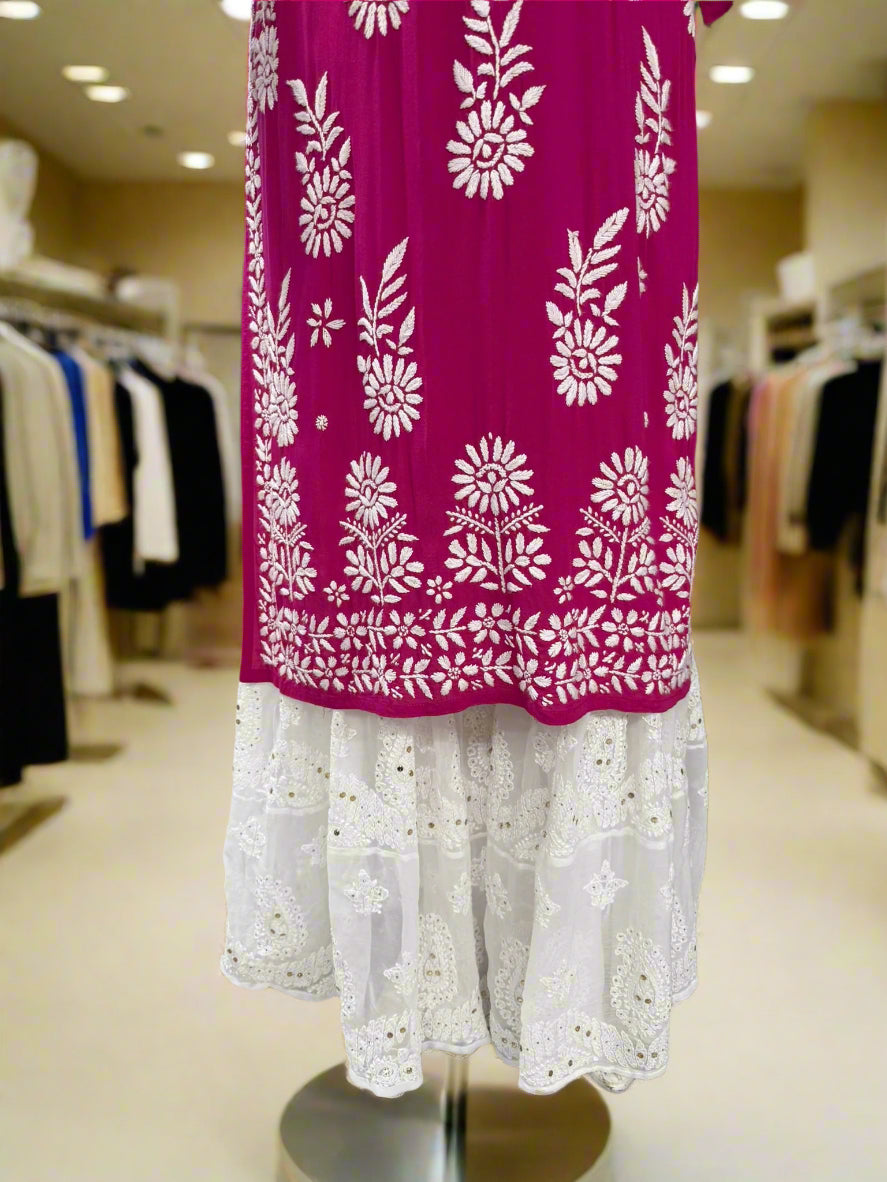 A traditional white Georgette Gharara with Chikankari hand embroidery displayed on a mannequin. The bottom flare has kaamdani work details.