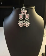 white AD (Artificial Diamond) two earrings and a maang tikka set includes pink centre stones by famaza couture 