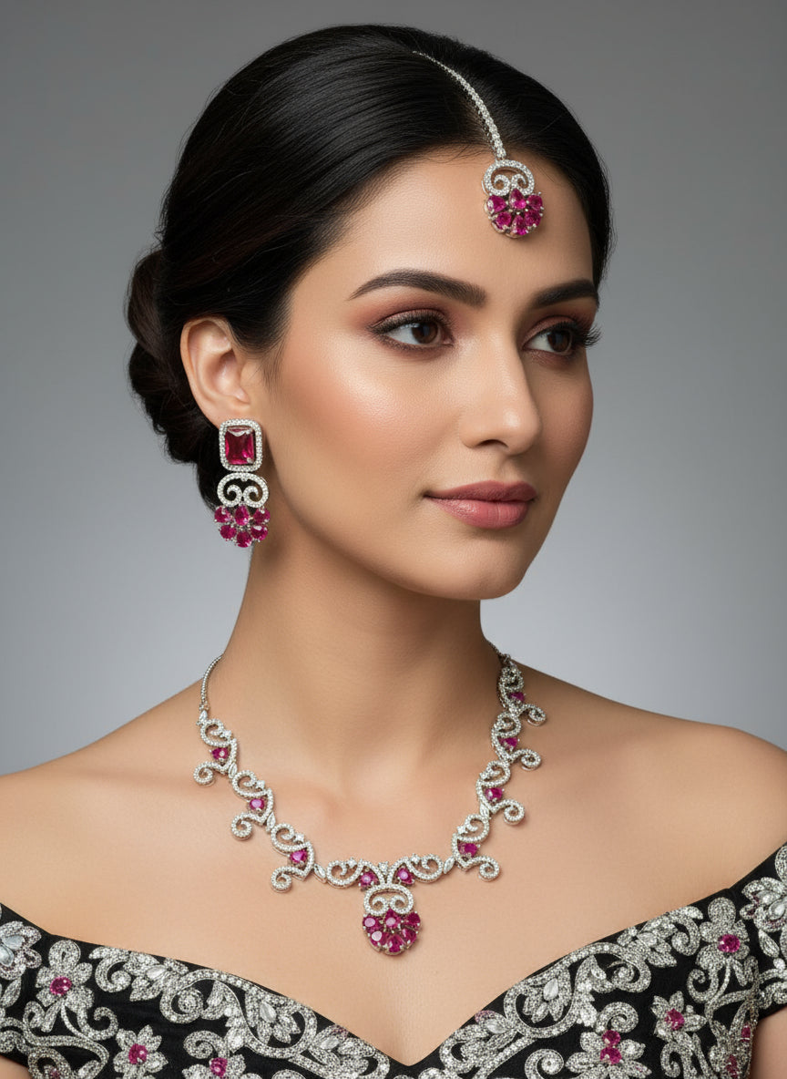 white American diamond stones with hot pink stone in the centre on this jewellery set includes necklace, earrings and maang tikka by famaza couture 
